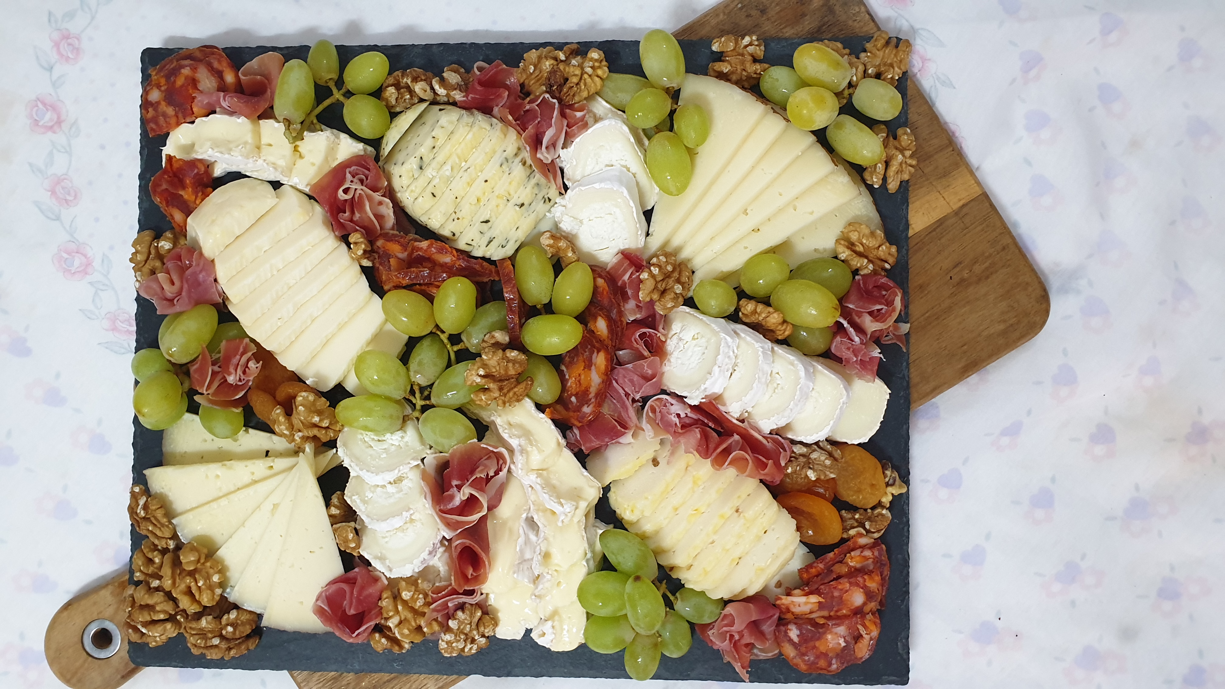 Tábua de queijos, enchidos, uvas e frutos secos